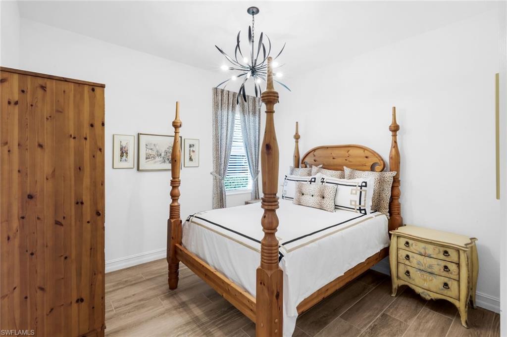 14630 Blue Bay Circle Fort Myers, FL 33913 - Photo 18 of 43 a bedroom with a bed and a chandelier