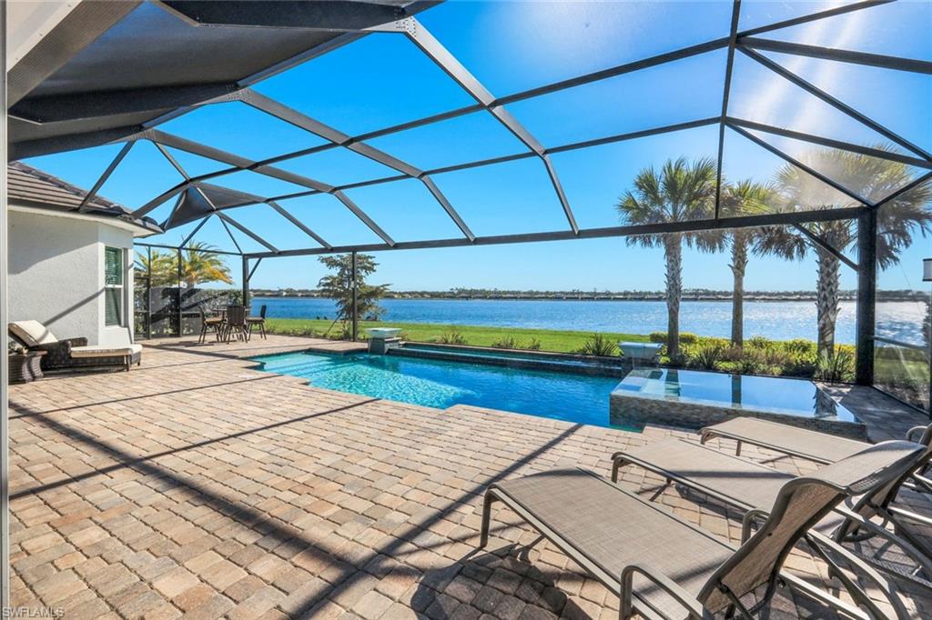 14630 Blue Bay Circle Fort Myers, FL 33913 - Photo 29 of 43 a view of a patio with a table and chairs under an umbrella