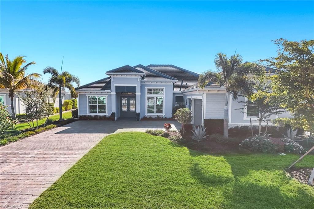 14630 Blue Bay Circle Fort Myers, FL 33913 - Photo 4 of 43 a front view of a house with a yard