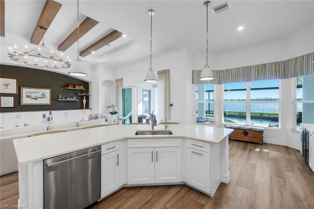 14630 Blue Bay Circle Fort Myers, FL 33913 - Photo 10 of 43 a large white kitchen with a large window a sink and stainless steel appliances