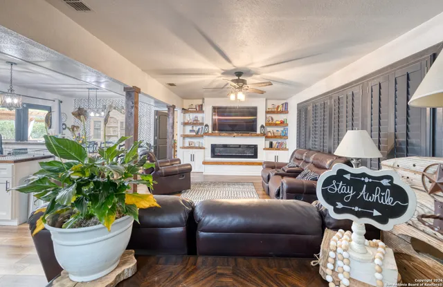 a living room with furniture and a potted plant
