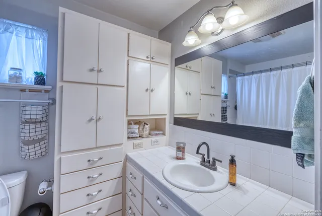 a bathroom with a sink double vanity and a mirror