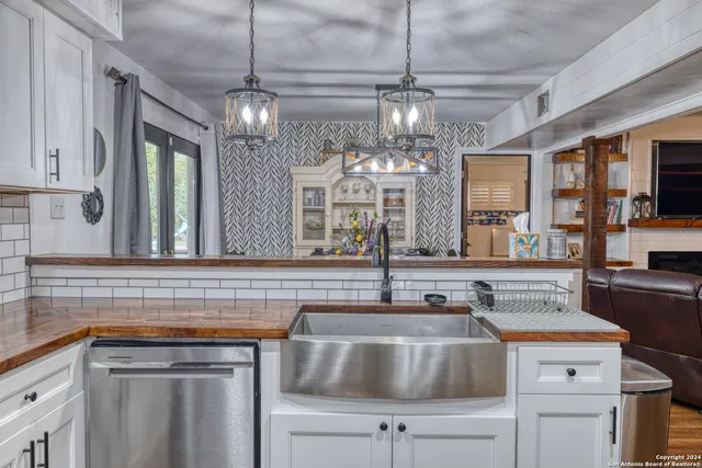 a kitchen with a sink and chandelier