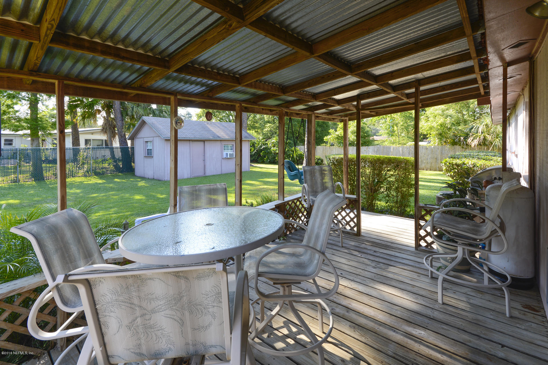 2104 Dean Road Jacksonville, FL 32216 - Photo 3 of 20 a patio with table and chairs and potted plants