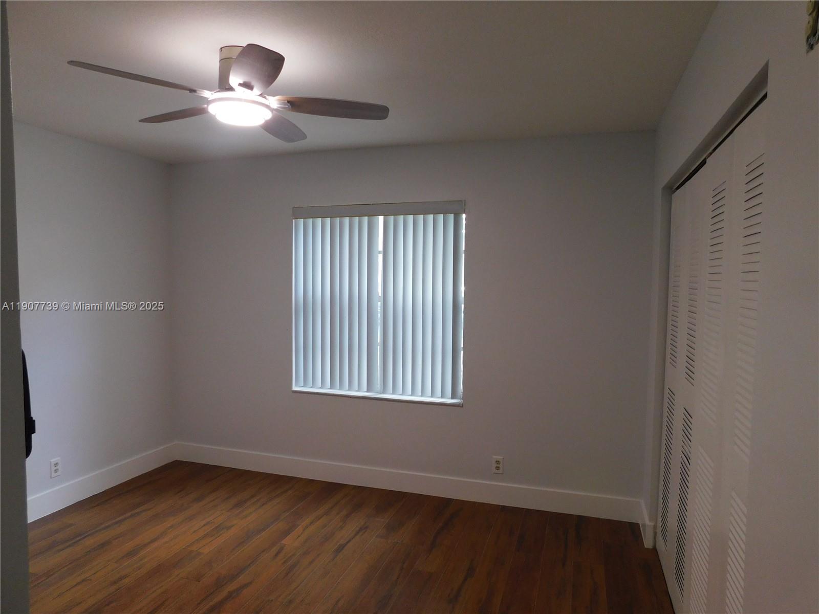 2851 River Run Circle West, Unit 2851 Miramar, FL 33025 - Photo 11 of 33 a view of an empty room with a window and wooden floor