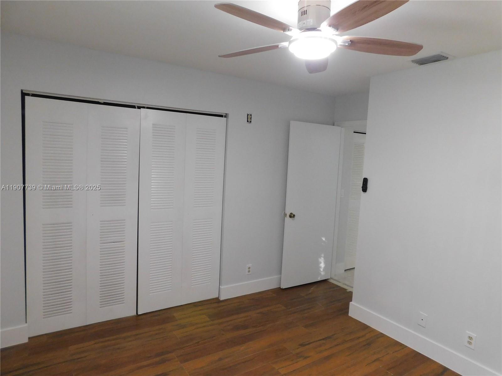 2851 River Run Circle West, Unit 2851 Miramar, FL 33025 - Photo 15 of 33 a view of an empty room with wooden floor