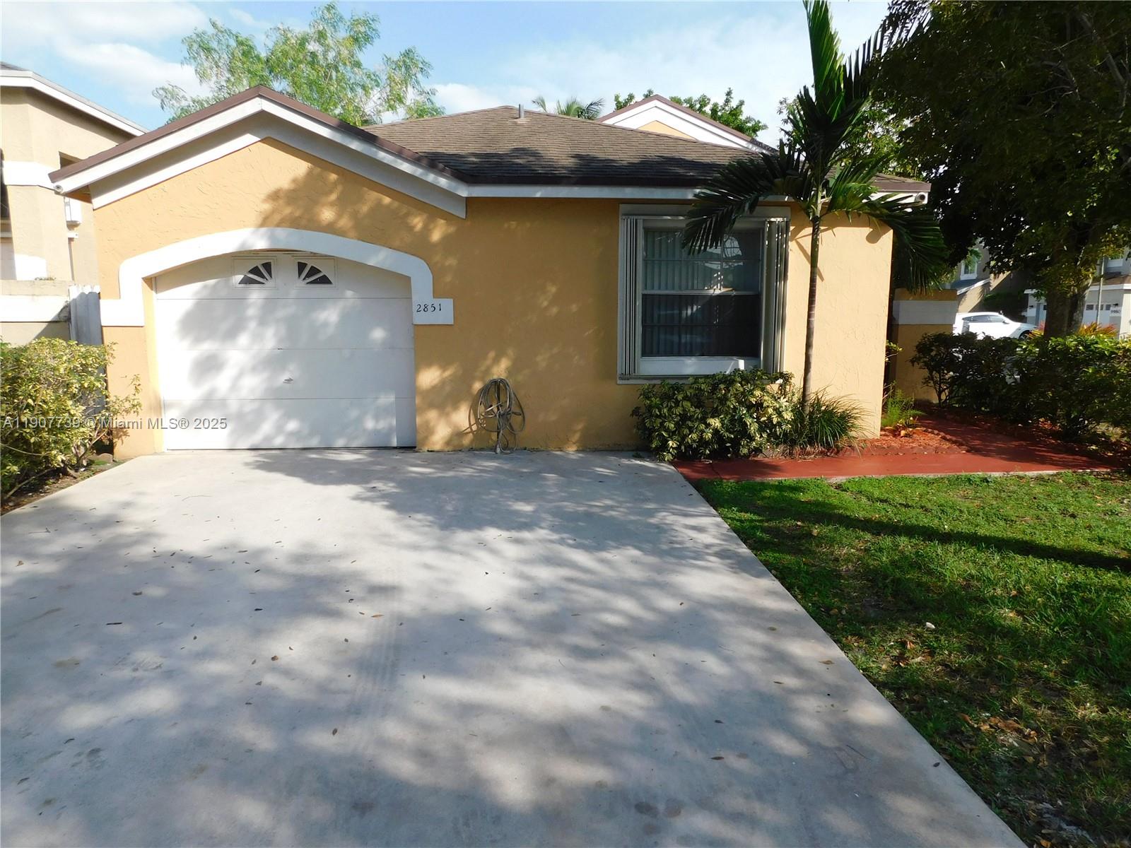 2851 River Run Circle West, Unit 2851 Miramar, FL 33025 - Photo 18 of 33 a front view of a house with garden