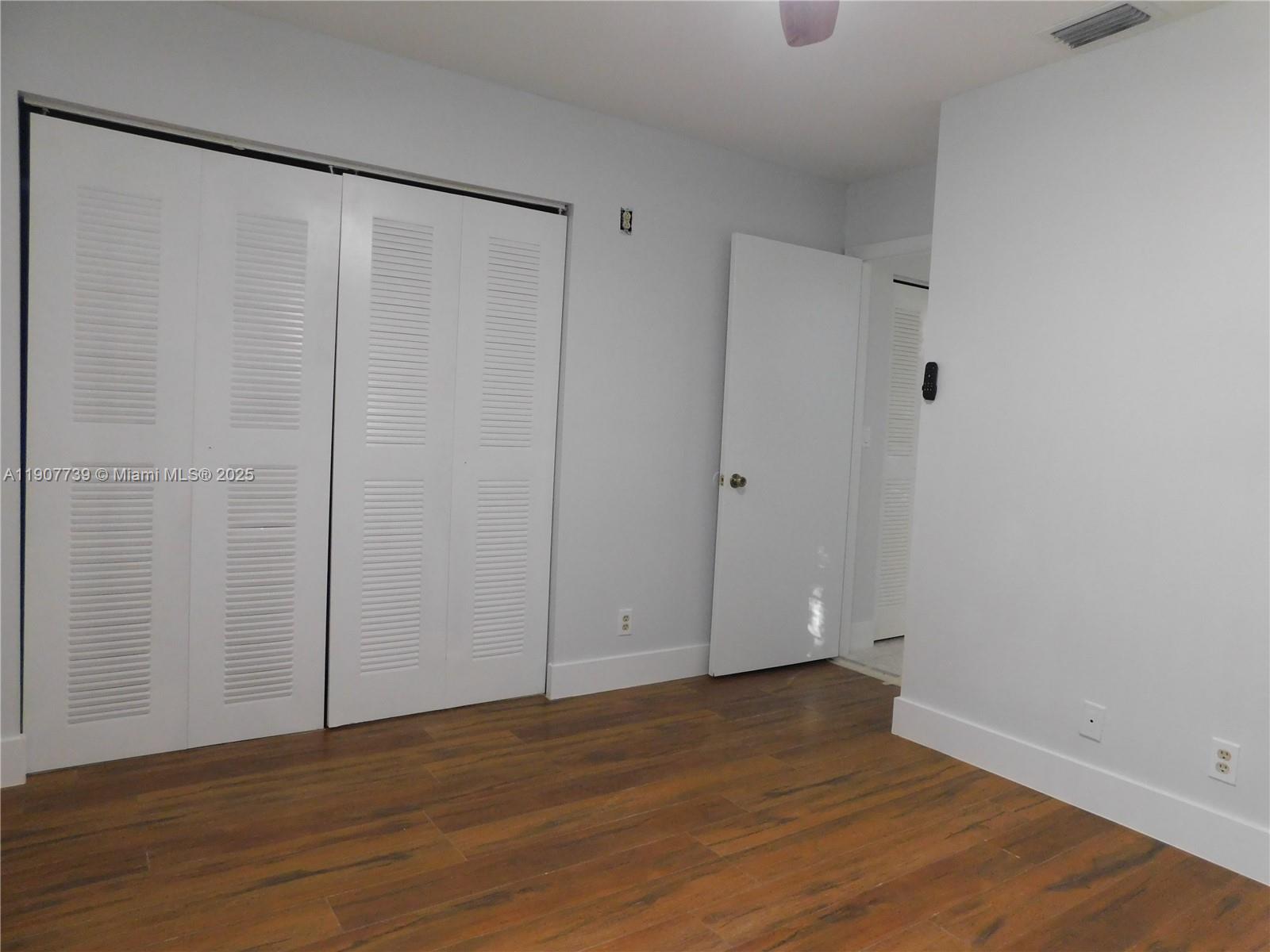2851 River Run Circle West, Unit 2851 Miramar, FL 33025 - Photo 20 of 33 a view of an empty room with wooden floor
