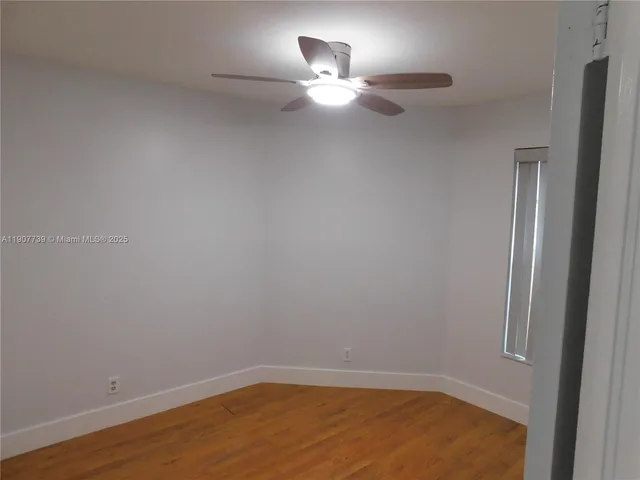 a room with a light fixture and a fan