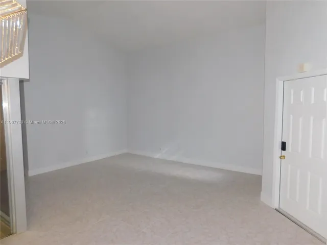 a view of a chandelier in big room and chandelier fan