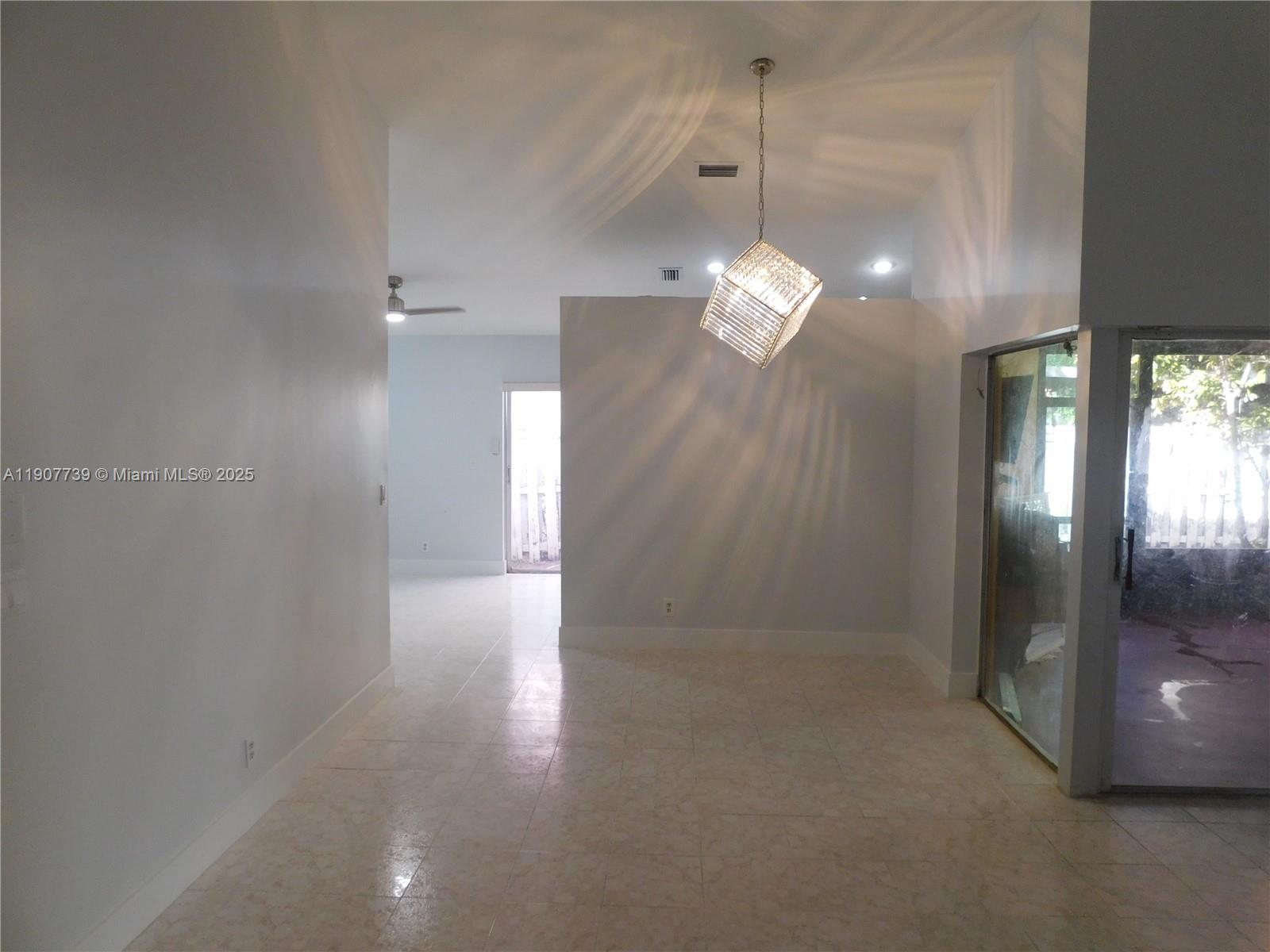 2851 River Run Circle West, Unit 2851 Miramar, FL 33025 - Photo 25 of 33 a view of a chandelier in big room and chandelier fan