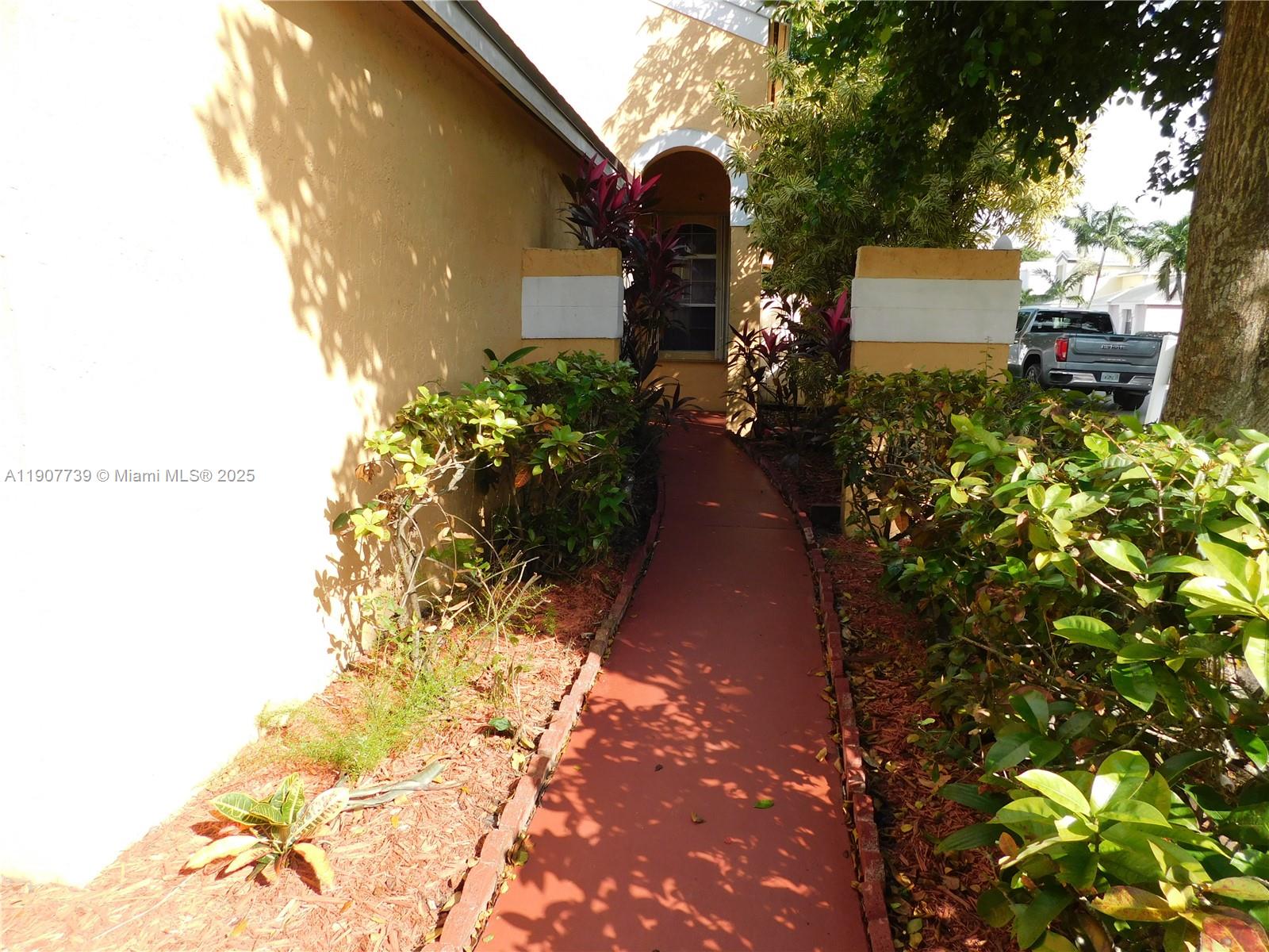 2851 River Run Circle West, Unit 2851 Miramar, FL 33025 - Photo 3 of 33 a front view of a house with a yard