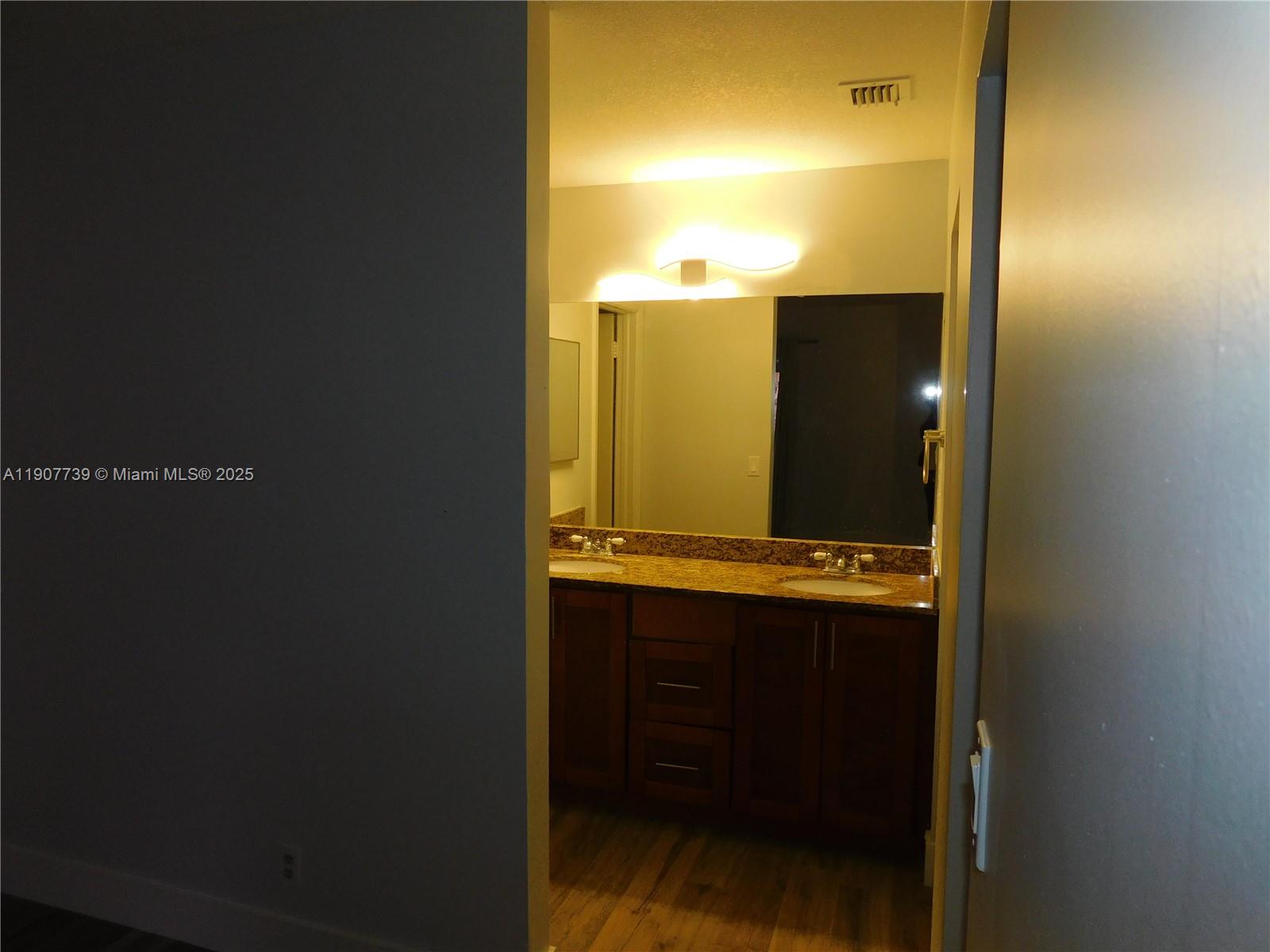 2851 River Run Circle West, Unit 2851 Miramar, FL 33025 - Photo 31 of 33 a bathroom with a sink and mirror