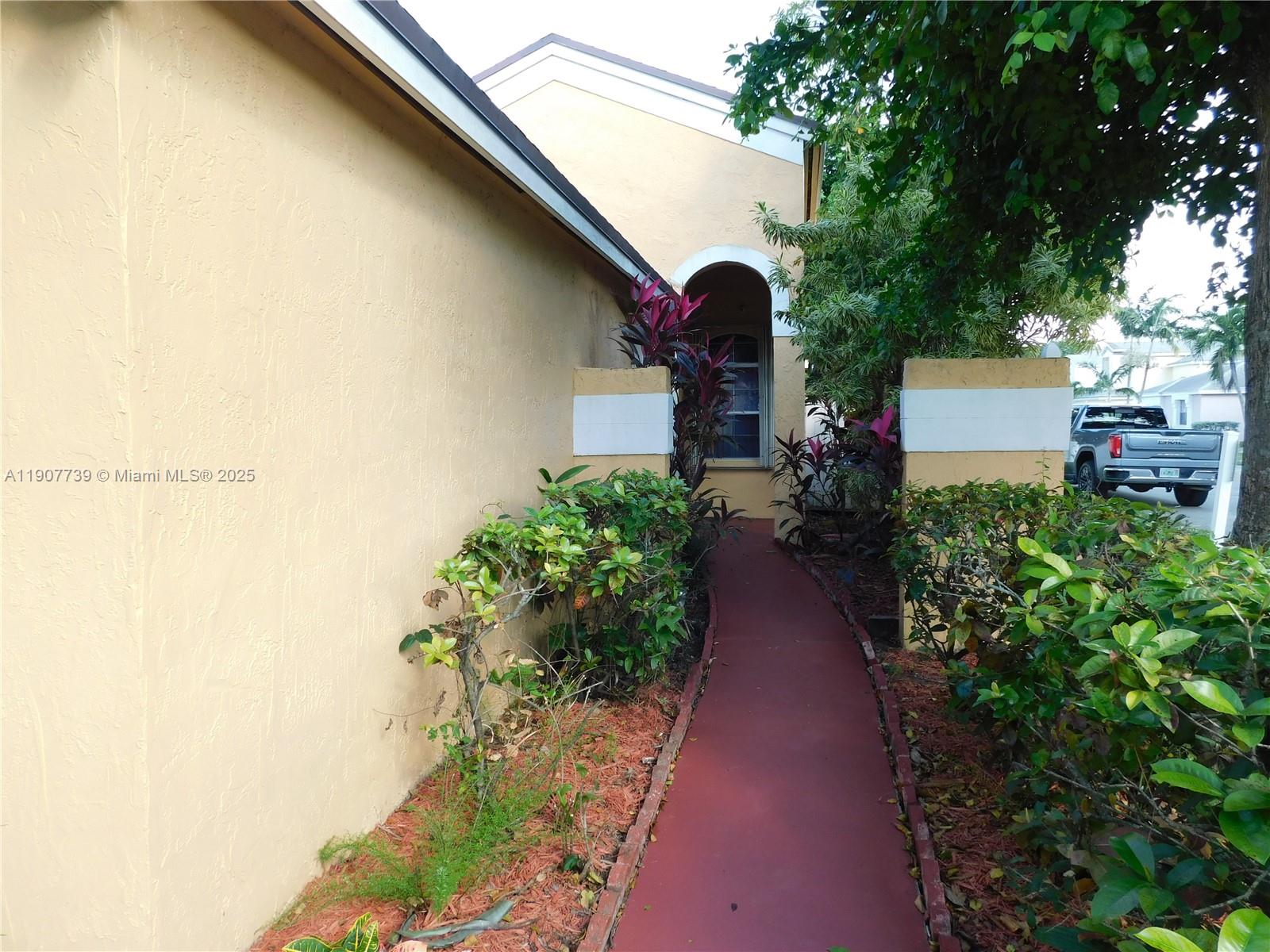 2851 River Run Circle West, Unit 2851 Miramar, FL 33025 - Photo 32 of 33 a view of a pathway covered with flower plants