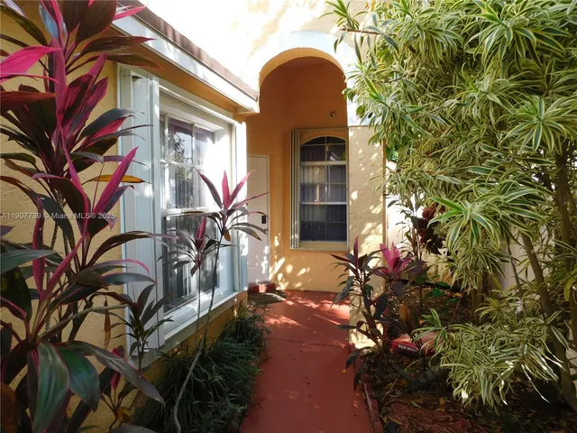 a view of a house with a tree