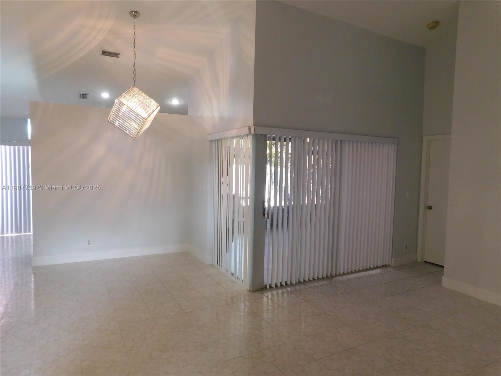 2851 River Run Circle West, Unit 2851 Miramar, FL 33025 - Photo 5 of 33 an empty room with wooden floor and windows