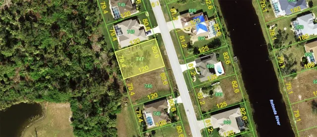 an aerial view of a residential houses with yard