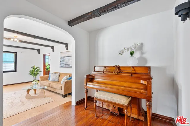a bedroom with furniture and a wooden floor