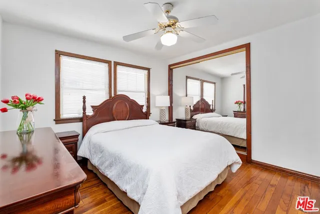 a bedroom with two beds and a potted plant