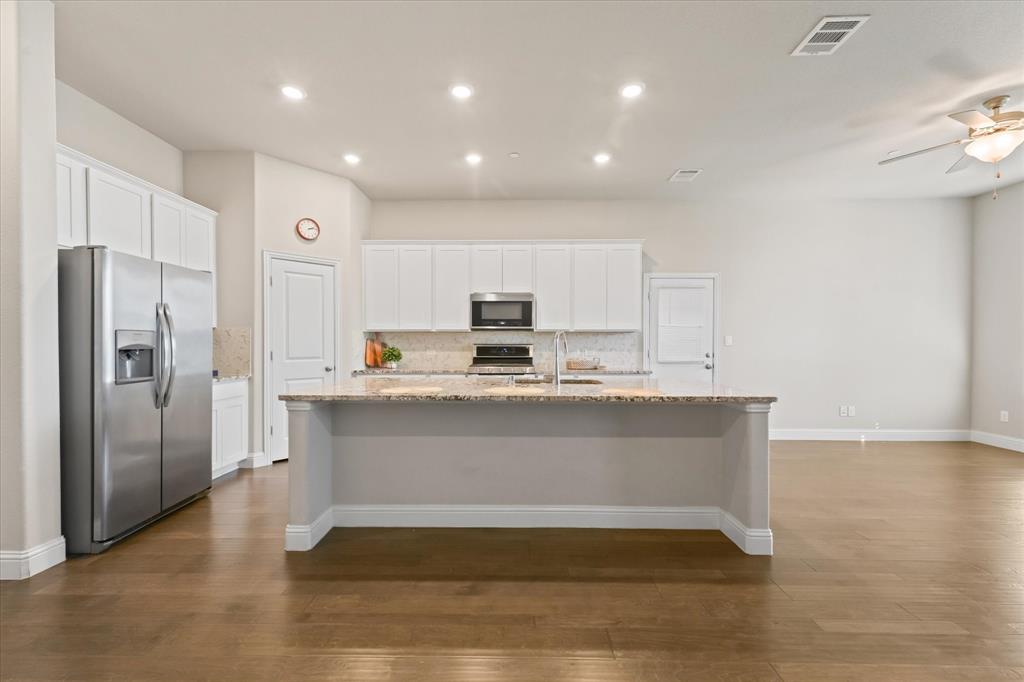 7401 Sunset Boulevard Rowlett, TX 75088 - Photo 12 of 35 a view of kitchen with stainless steel appliances granite countertop cabinets and wooden floor