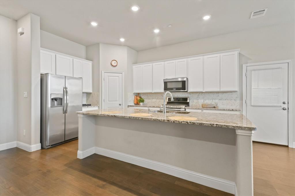 7401 Sunset Boulevard Rowlett, TX 75088 - Photo 13 of 35 a kitchen with stainless steel appliances granite countertop a refrigerator a stove and a sink