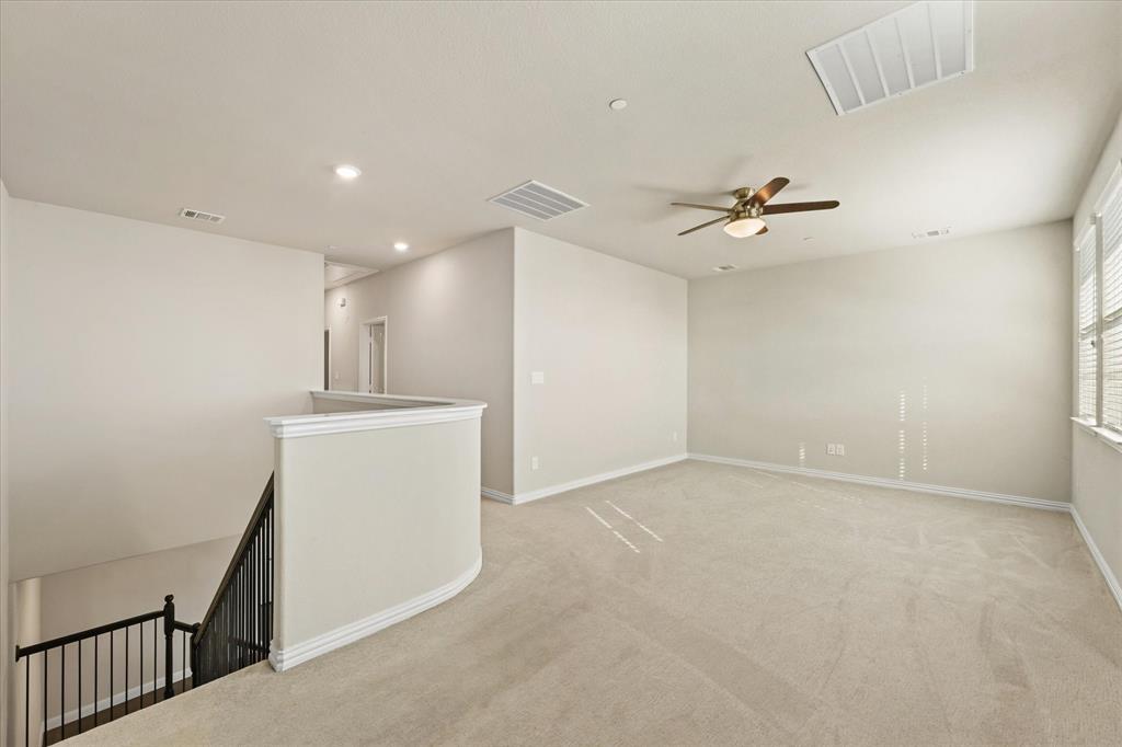 7401 Sunset Boulevard Rowlett, TX 75088 - Photo 17 of 35 a view of an empty room with a ceiling fan