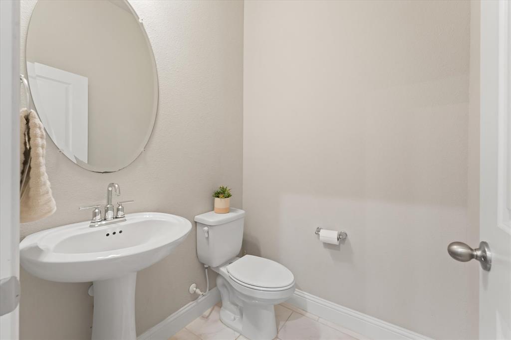 7401 Sunset Boulevard Rowlett, TX 75088 - Photo 17 of 35 a bathroom with a sink toilet and a mirror