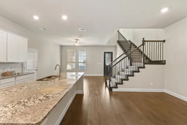 a bathroom with a sink toilet double vanity and shower
