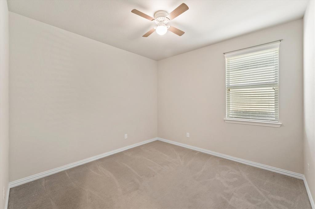 7401 Sunset Boulevard Rowlett, TX 75088 - Photo 20 of 35 an empty room with a window and a fan