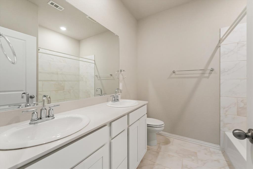 7401 Sunset Boulevard Rowlett, TX 75088 - Photo 21 of 35 a bathroom with a sink toilet double vanity and shower