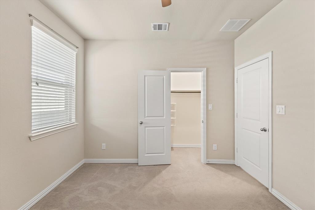 7401 Sunset Boulevard Rowlett, TX 75088 - Photo 21 of 35 an empty room with windows and closet