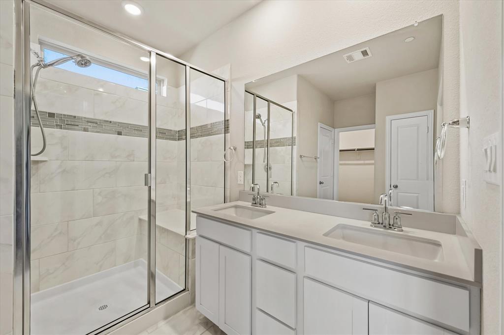 7401 Sunset Boulevard Rowlett, TX 75088 - Photo 25 of 35 a bathroom with a shower sink and mirror
