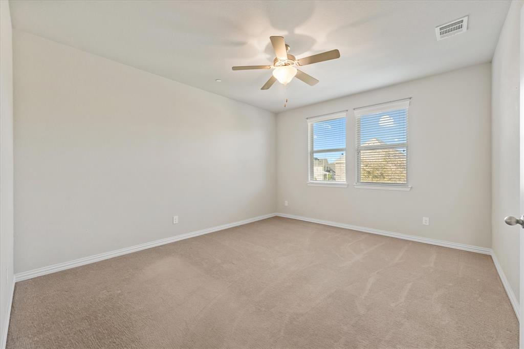 7401 Sunset Boulevard Rowlett, TX 75088 - Photo 29 of 35 an empty room with windows and fan