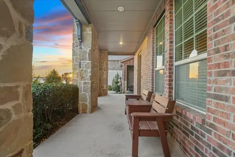 a balcony with outdoor seating and city view
