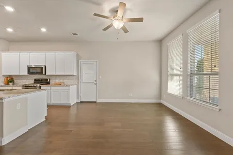 a kitchen with white cabinets and white appliances