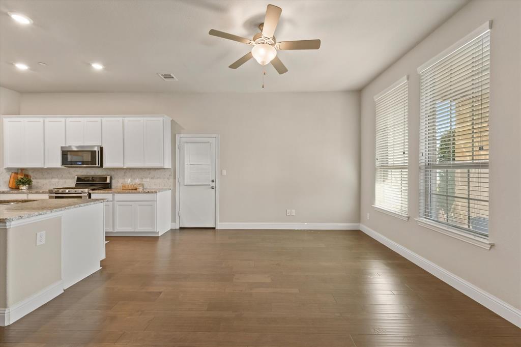 7401 Sunset Boulevard Rowlett, TX 75088 - Photo 8 of 35 a kitchen with white cabinets and white appliances