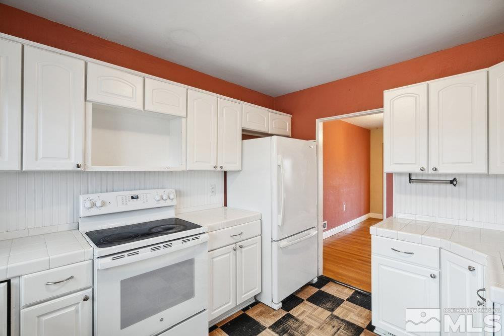 847 Washington Street Reno, NV 89503 - Photo 11 of 29 a kitchen with white cabinets and white appliances