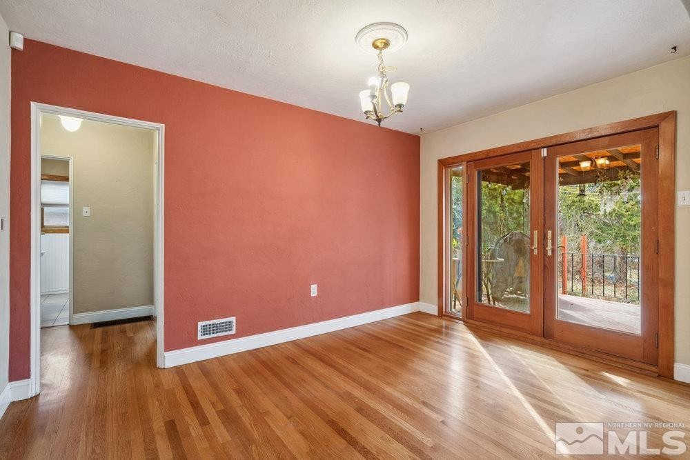 847 Washington Street Reno, NV 89503 - Photo 13 of 29 a view of an empty room with wooden floor and a window