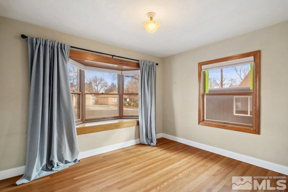 847 Washington Street Reno, NV 89503 - Photo 18 of 29 a view of an empty room with a window and wooden floor