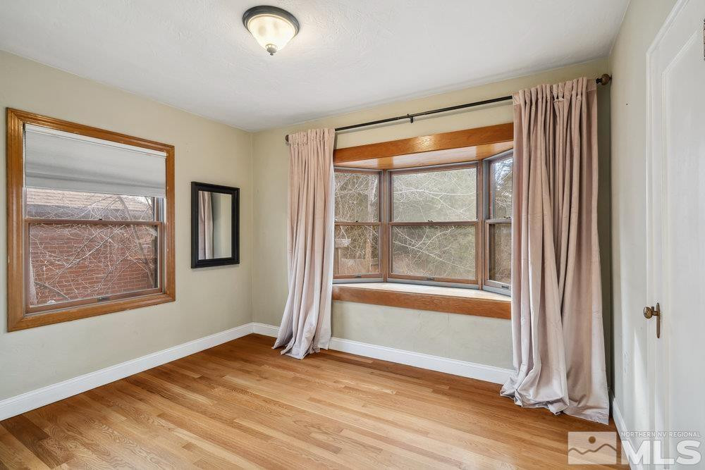 847 Washington Street Reno, NV 89503 - Photo 21 of 29 a view of an empty room with a window and wooden floor
