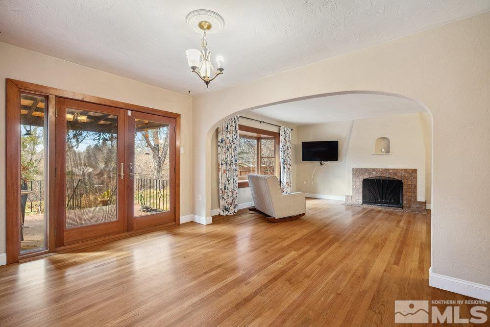 847 Washington Street Reno, NV 89503 - Photo 8 of 29 a view of a livingroom with wooden floor a fireplace and window
