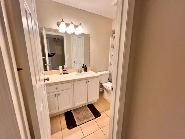 a bathroom with a sink mirror and a shower