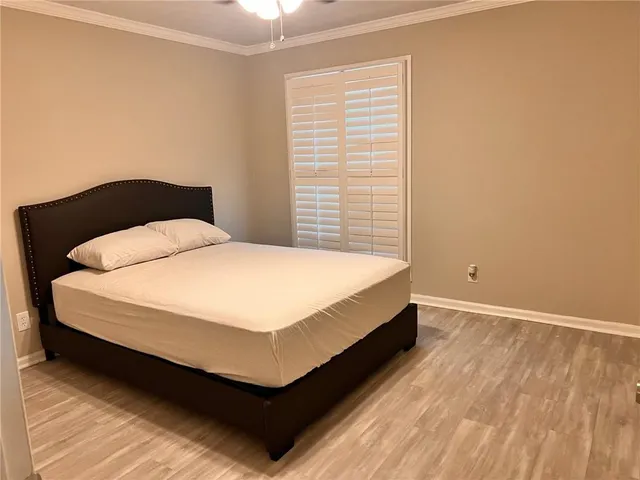 a large bed sitting in a bedroom next to a window