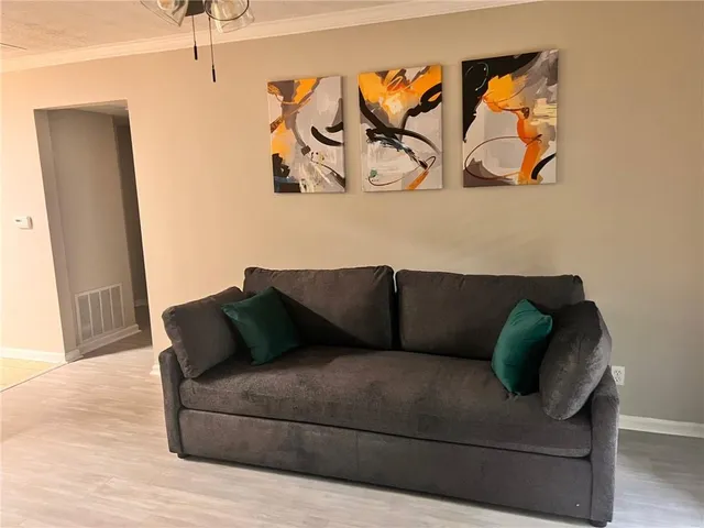 a living room with furniture and wall painting