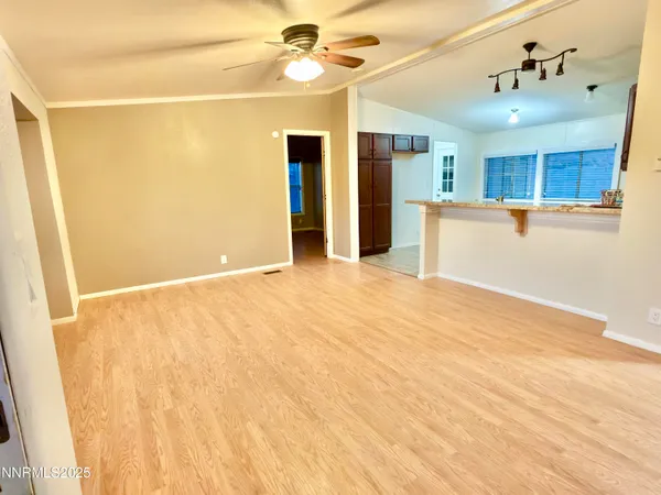 a view of an empty room with wooden floor