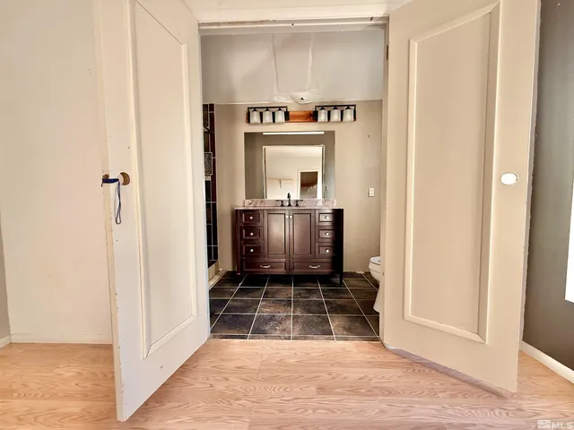a bathroom with a granite countertop sink a vanity and a shower
