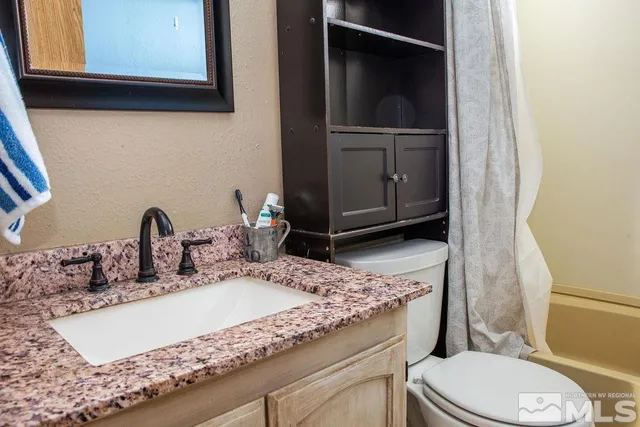 a view of a hallway with wooden floor and windows