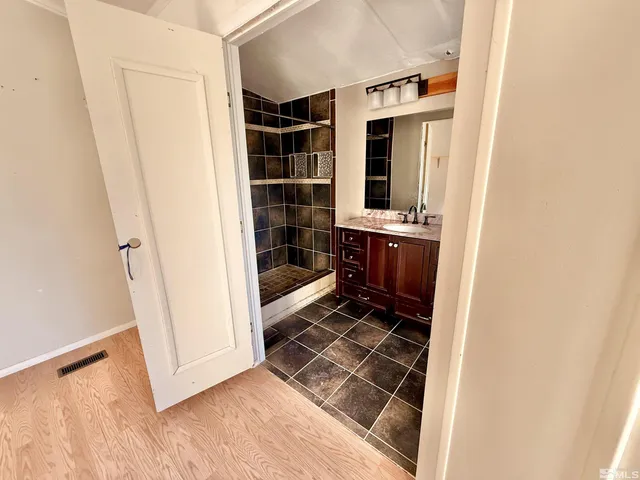 a view of a house with wooden fence