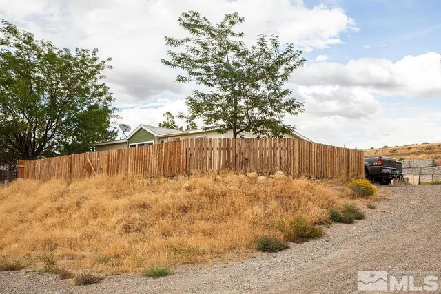 a backyard of a house with wooden fence