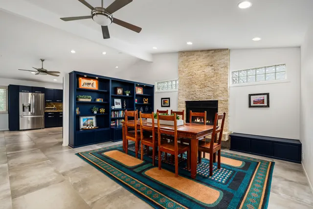 a living room with furniture a table and kitchen view